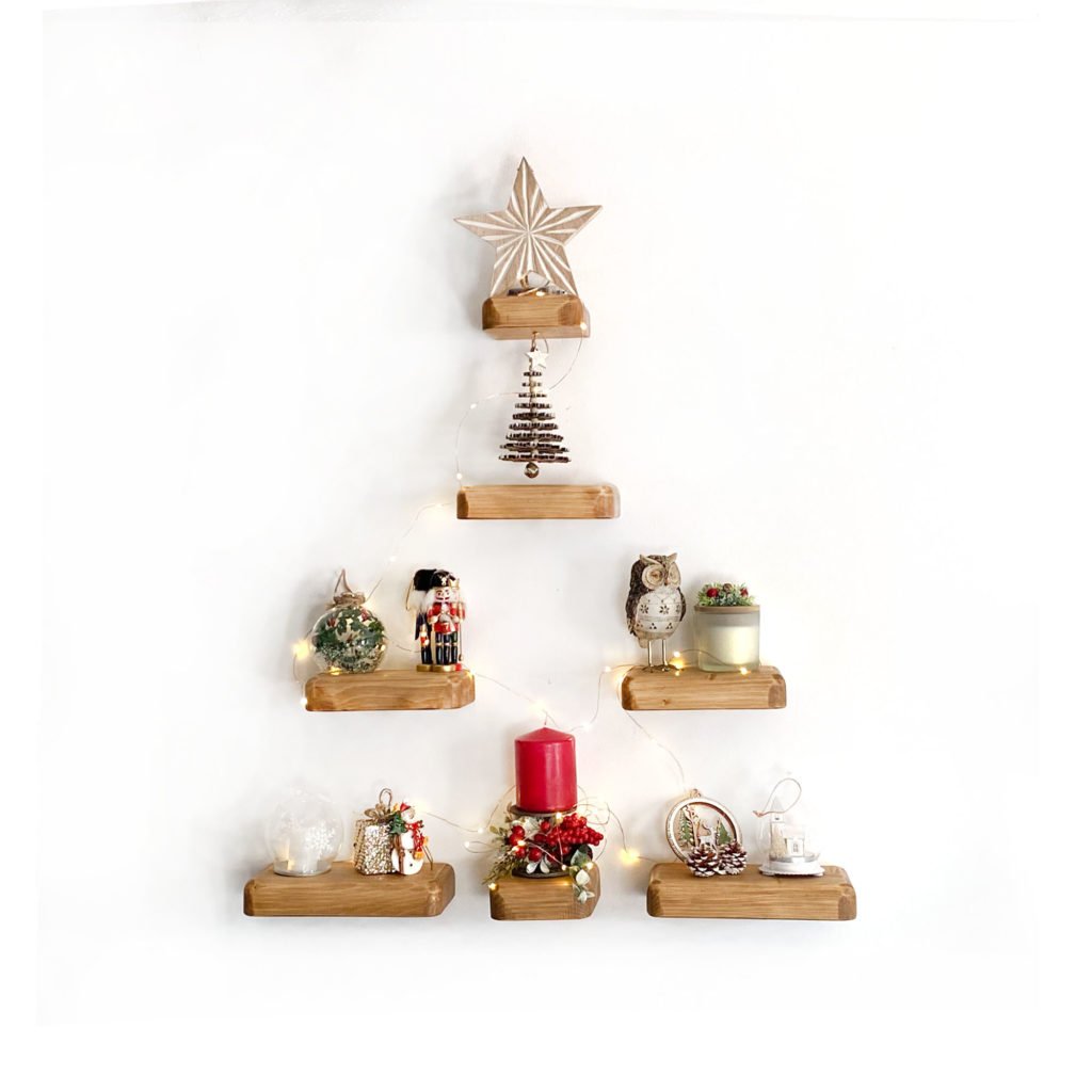 7 mini floating shelves arranged as a christmas tree with xmas