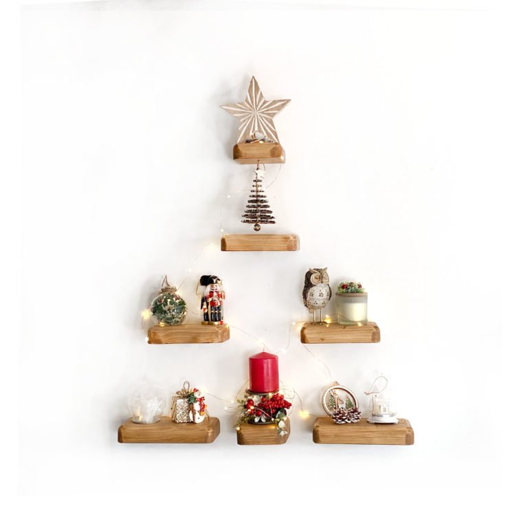 7 mini floating shelves arranged as a christmas tree with xmas
