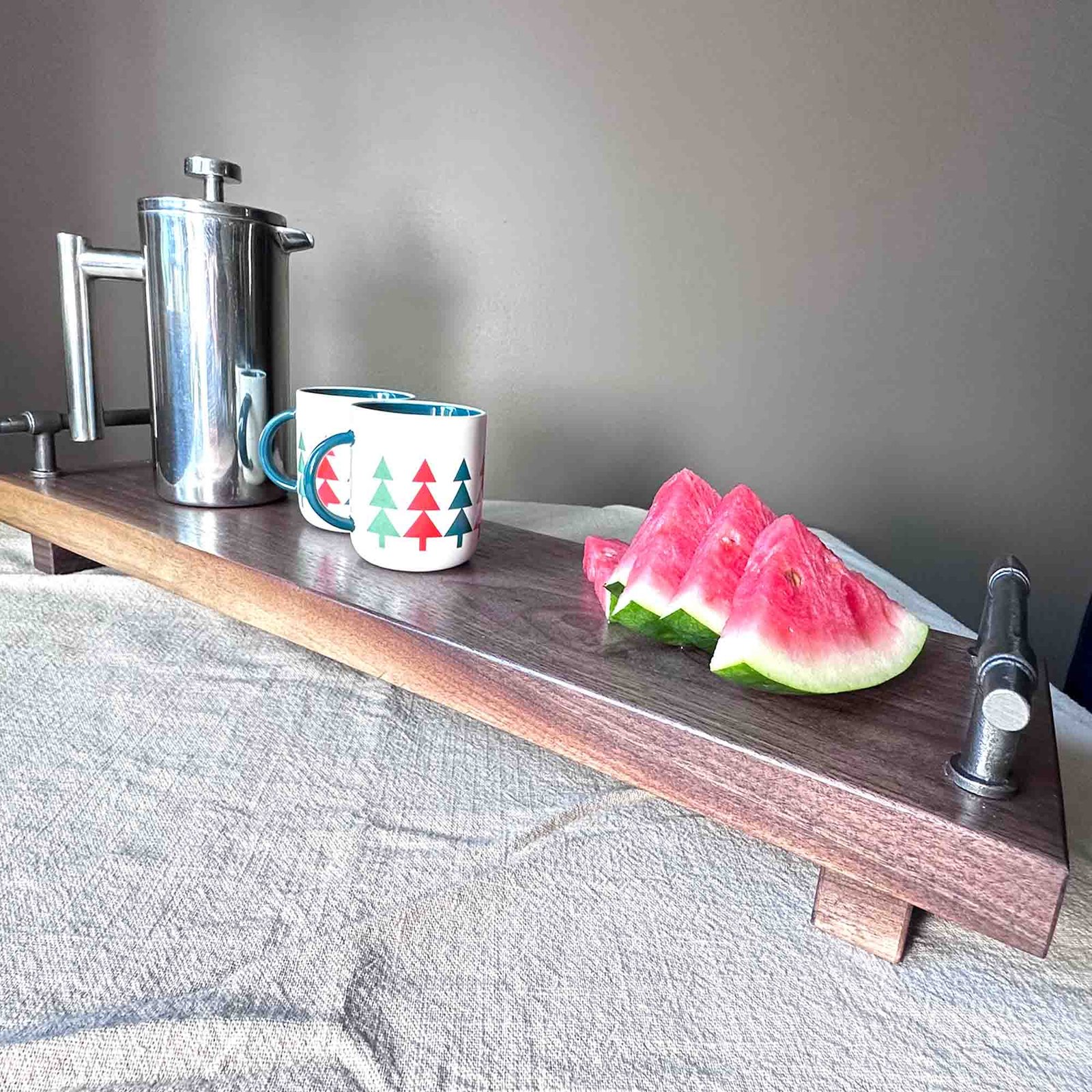 walnut serving tray with cast iron handles and coffee and water mellon