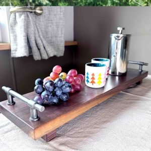 walnut serving tray with cast iron handles and coffee and grapes